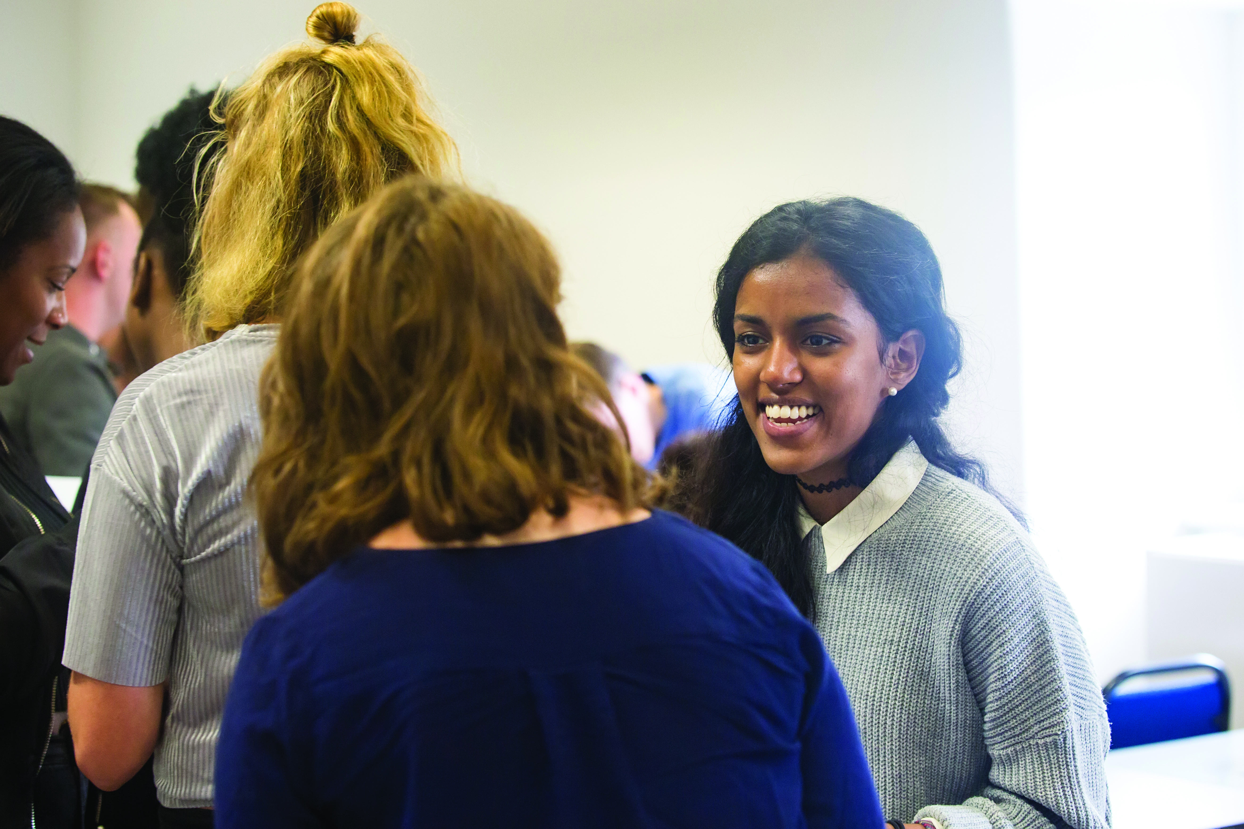 lady smiling through a crowd of people