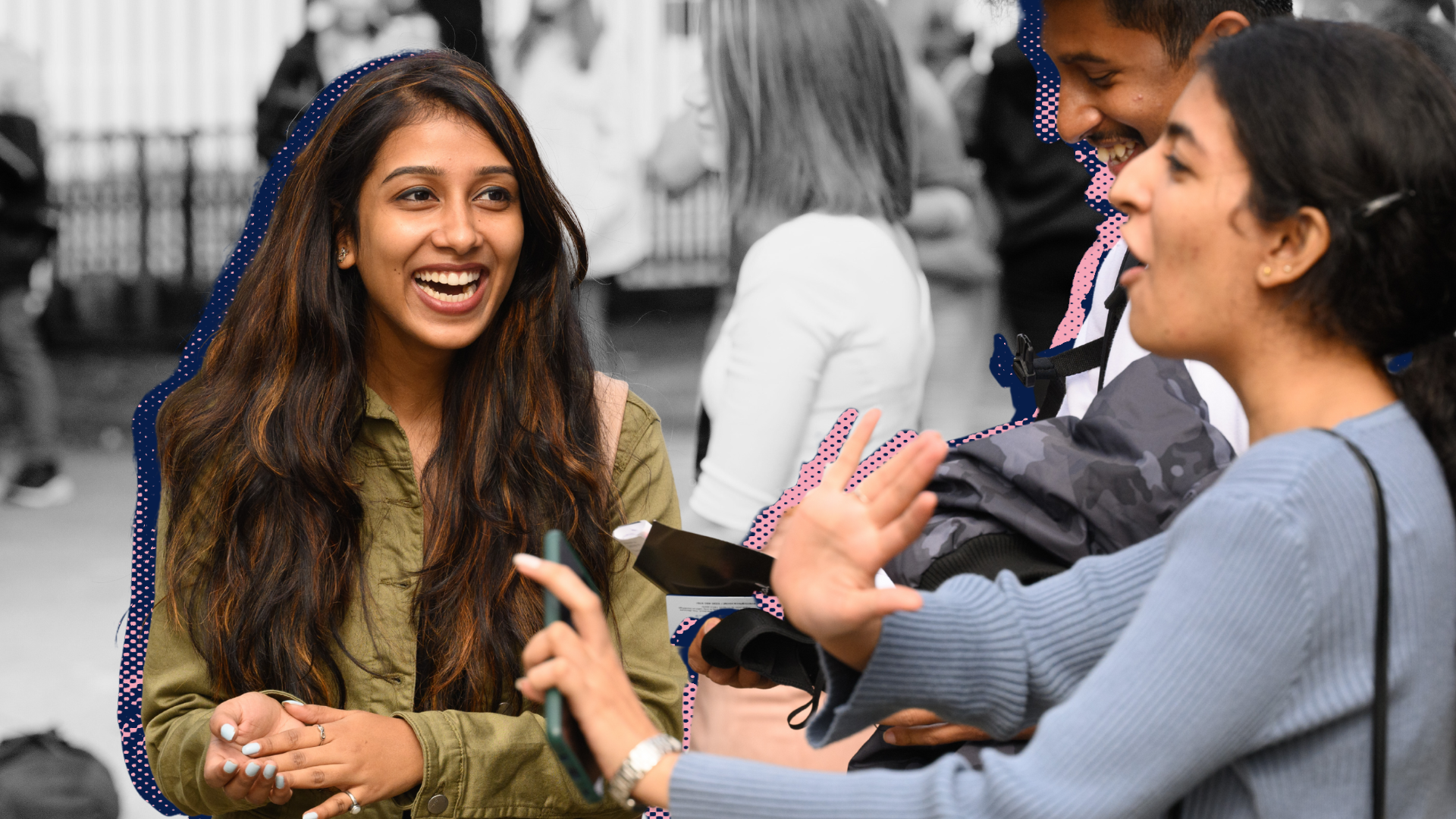 Group of three people in mid conversation smiling