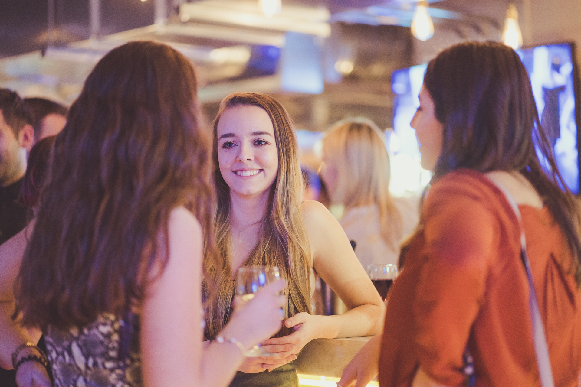 ladies talking in Lower Deck with glasses of wine