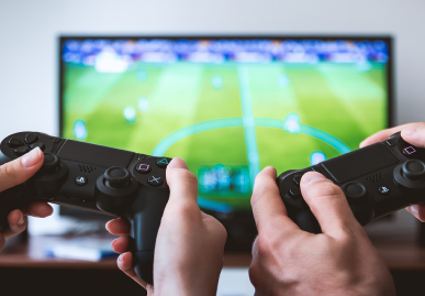 Image showing hands of two people holding play station controllers
