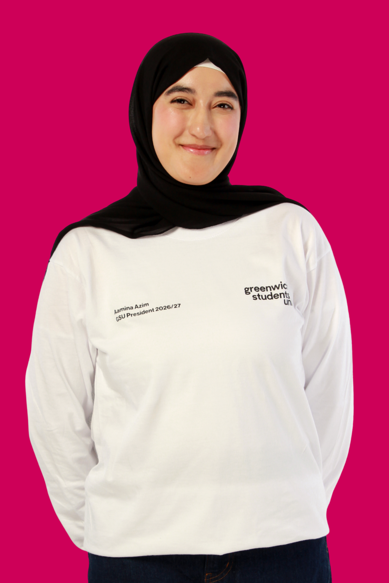 Aamina stood with arms behind her back smiling at the camera