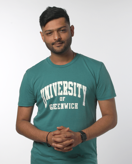 Man wearing a teal coloured t-shirt with University of Greenwich written across it
