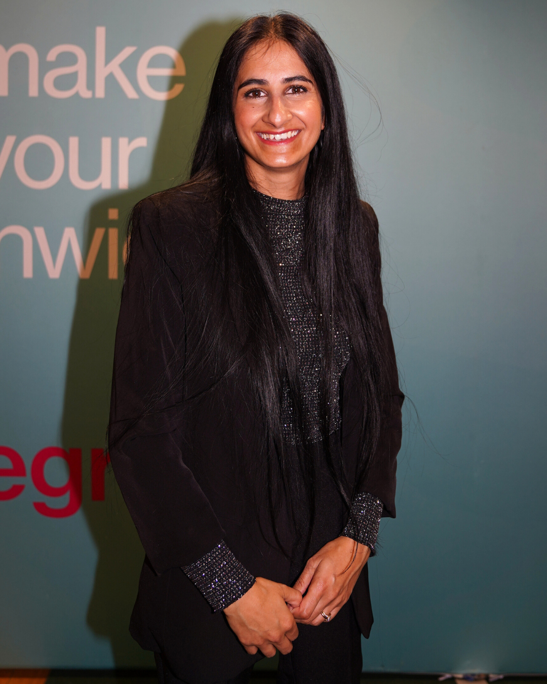 uzma dressed in smart black blazer smiling