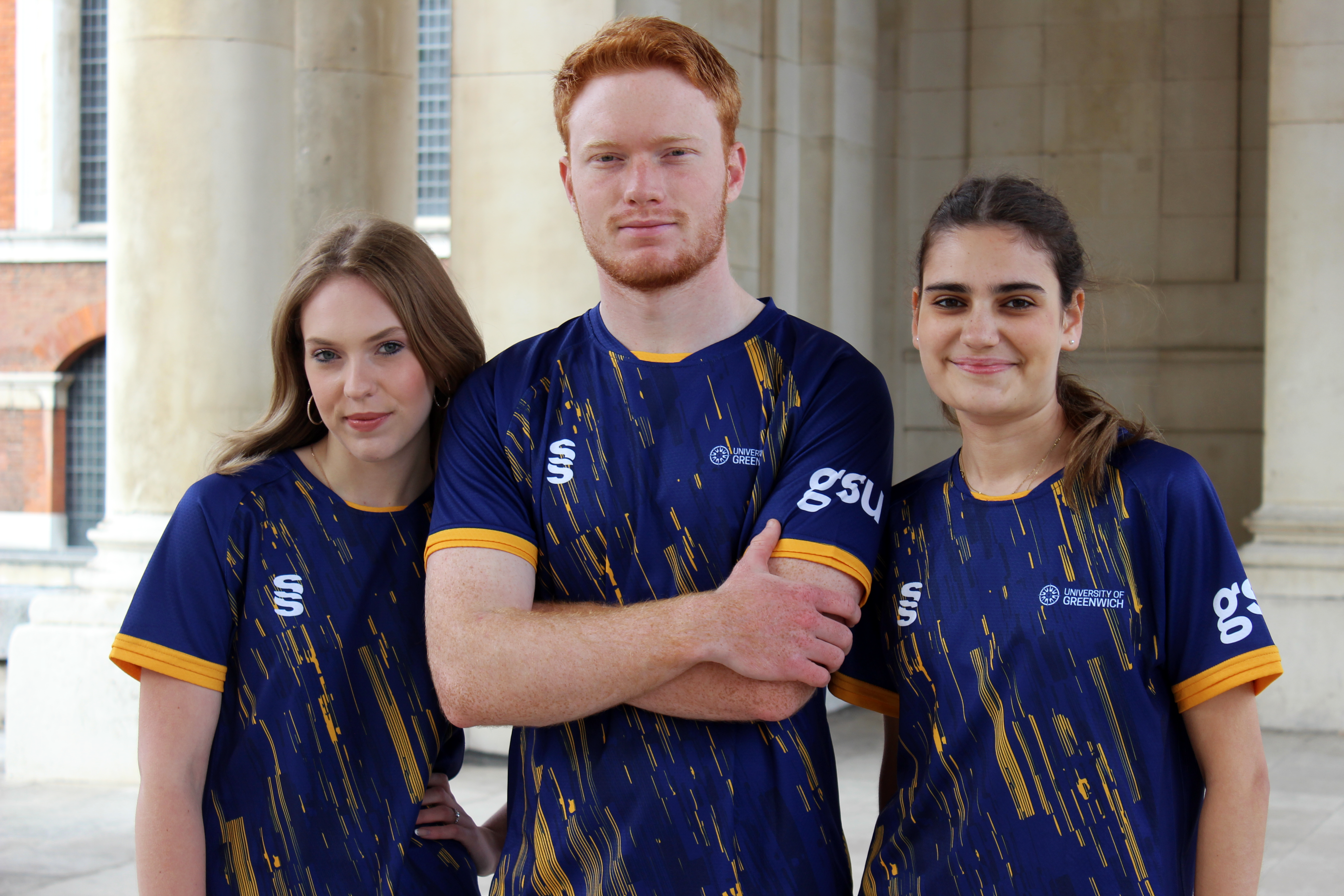 photo of hockey team standing with arms crossed on greenwich campus