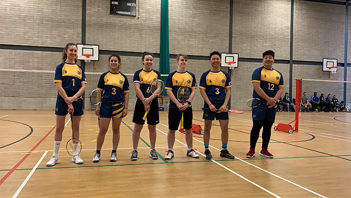 Badminton players inside sports hall