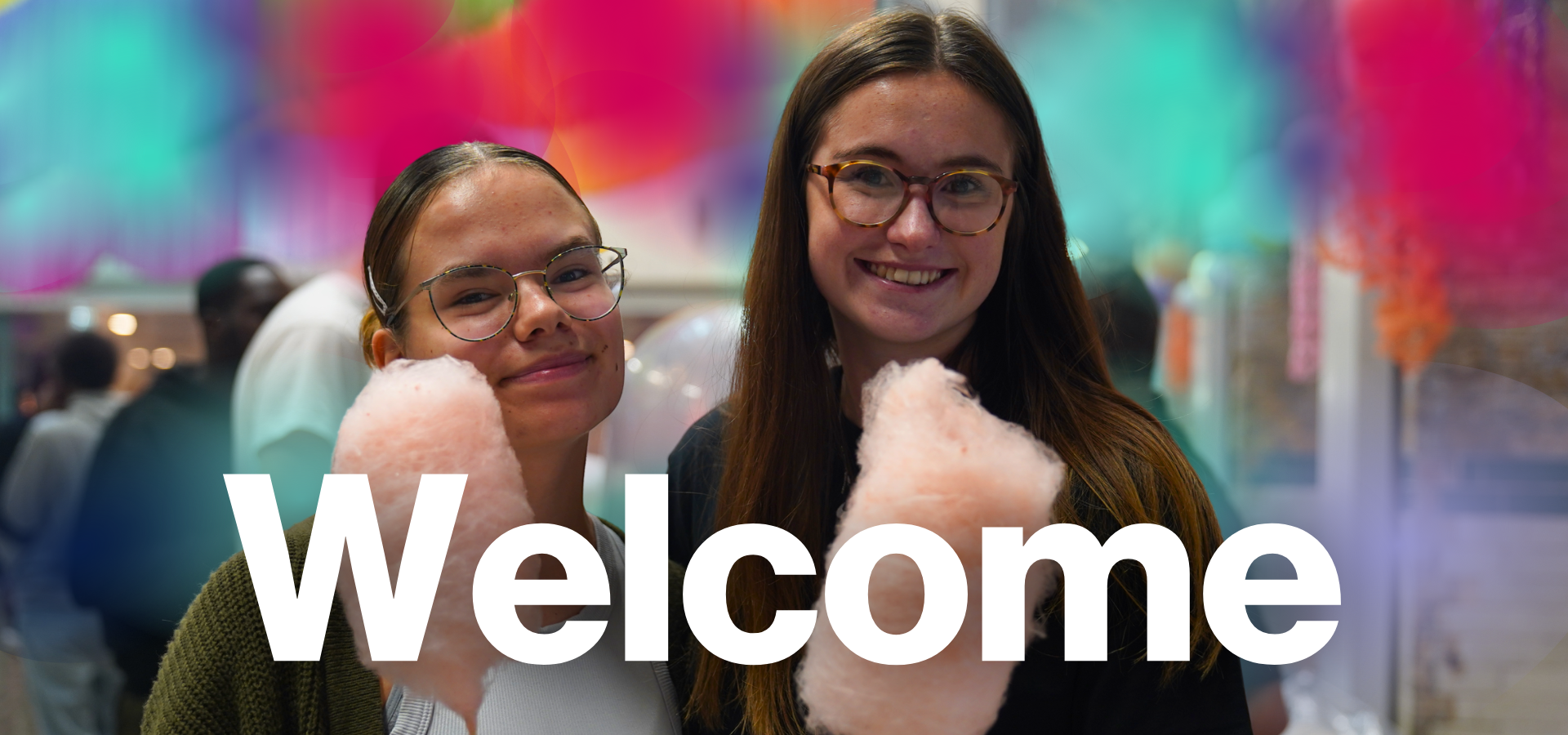two girls holding candyfloss and smiling at the camera, title reading "welcome"